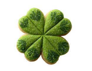 A vibrant four leaf clover shaped cookie with sparkling green sugar sprinkles