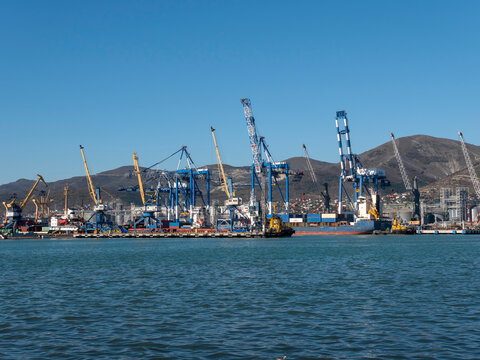 August 22 2025 View of Novorossiysk port Russia with cargo ships and cranes on the coastline. Industrial maritime scene on the Black Sea