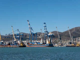 August 22 2025 View of Novorossiysk port Russia with cargo ships and cranes on the coastline. Industrial maritime scene on the Black Sea