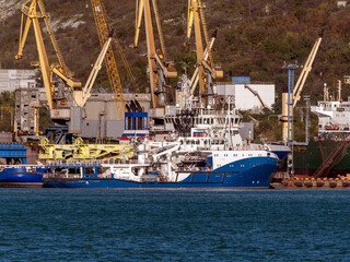 August 22 2025 View of Novorossiysk port Russia with cargo ships and cranes on the coastline. Industrial maritime scene on the Black Sea