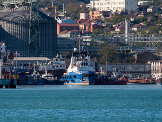 August 22 2025 View of Novorossiysk port Russia with cargo ships and cranes on the coastline. Industrial maritime scene on the Black Sea
