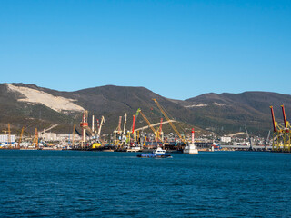 August 22 2025 View of Novorossiysk port Russia with cargo ships and cranes on the coastline. Industrial maritime scene on the Black Sea