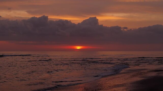 Static aerial drone view of a beautiful sunset and ocean waves at Playa Avellanas