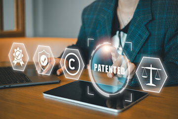 Businessperson using a digital interface to manage patents, copyrights, and legal concepts in a modern office environment.