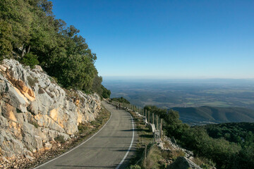 couple walking along the access road to the summit of Mare de Deu del Mon in Girona, Catalonia, Spain