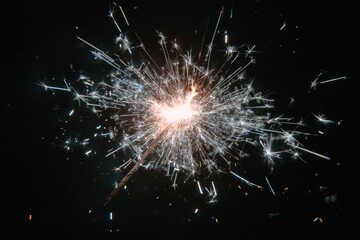 A sparkly object emitting numerous light trails against a dark, contrasting background