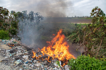shredded and pressed recyclable plastic waste that has been burned and causes environmental pollution.