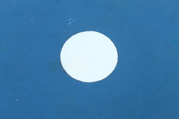 Details of sports field markings in the form of white circles on a blue surface