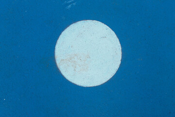 Details of sports field markings in the form of white circles on a blue surface