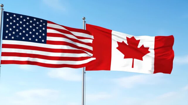 Dynamic display of American and Canadian flags waving vigorously in clear blue