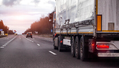Large cargo truck drives along multilane highway road. Vehicle transport shipping logistics...