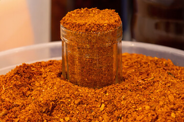 Spicy ground red chili paprika fiery finely powdered spice made from dried ground red peppers often including seeds and stems for extra heat