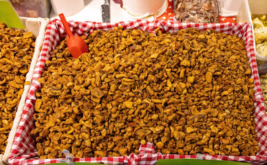 Homemade pork crackling beloved culinary traditional delicacy in Balkan crafted from carefully selected pieces of pork fat cut into small chunks and sold on local farmers market 