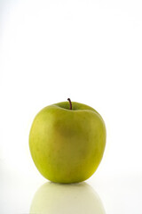 Green apple isolated on white background with reflection and copyspace.