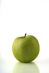 Green apple isolated on white background with reflection and copyspace.