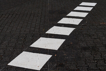 White pedestrian crossing on a city street during the day