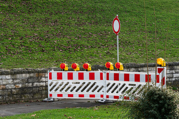 Roadblock and warning lights at construction site in city park
