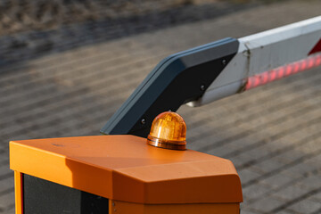 Barrier with warning light at entry point during daytime