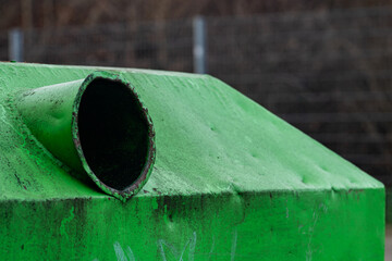 Green metal glass container with an open hole. Close up.