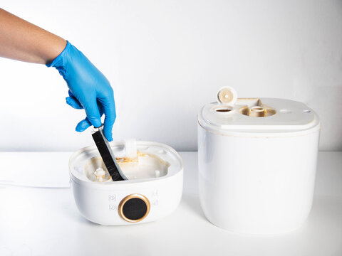 Cleaning the humidifier from scale, rust and unpleasant odors with a special brush and chemical agent. Service, close-up. Copy space for text