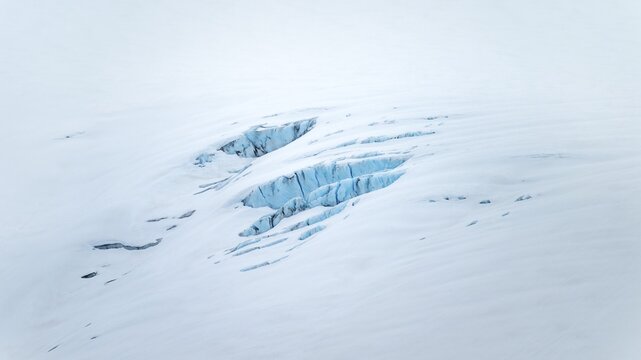 Smooth white snowy area on the glacier broken by crevasses with blue rugged glacial ice, detail, Exit Glacier, Kenai Peninsula, Alaska, USA