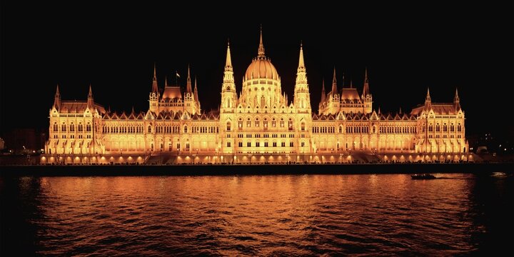 Hungarian parliament building viewed from the Danube River at night, Budapest, Hungary