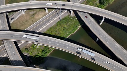 Travel by driving on highway interchange with cars on road trip and trucks shipping and transporting consumer products in America
