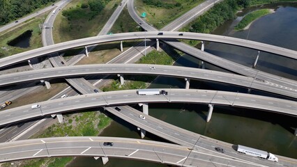 Travel by driving on highway interchange with cars on road trip and trucks shipping and transporting consumer products in America