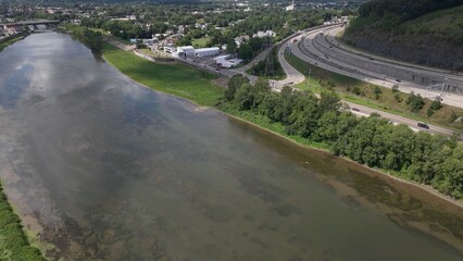 Driving on interstate highway in Binghamton City in New York State beside peaceful river in summer