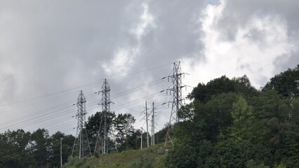 Electric power lines on Mountain top with storms clouds forming 