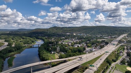 Driving on interstate highway in Binghamton City in New York State beside peaceful river in summer