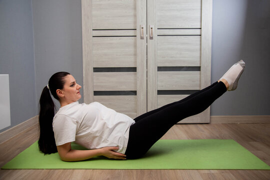 Woman performing V-sit exercise on yoga mat indoors, focus on core strength and abdominal muscles training, fitness routine at home for healthy lifestyle