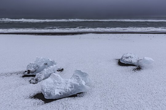 Ice floes on the beach, snowy, waves, sea, clouds, winter, Diamond Beach, Breidamerkursandur, J&ouml;kulsarlon, Iceland