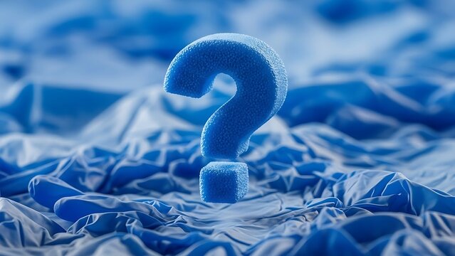 Blue question mark on crumpled paper background symbolizing confusion