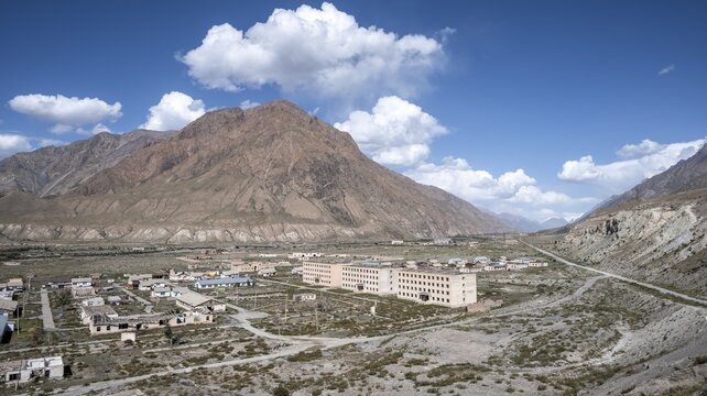 Town view, Abandoned buildings in barren landscape, Ghost town Enilchek in the Tien Shan Mountains, Ak-Su, Kyrgyzstan
