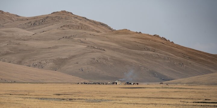 Traditional yurts at Songk&ouml;l on a plateau, mountains in the background, Kyrgyzstan