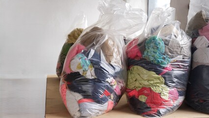 Large bags filled with donated clothes prepared for charity distribution. Humanitarian aid, social support, clothing donation, helping people in need and community assistance