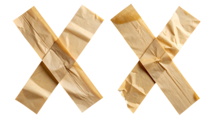 Two strips of tan tape crisscrossing against a black backdrop, forming an X