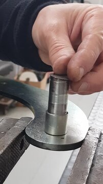 A mechanic installs a retaining ring on a shaft.
