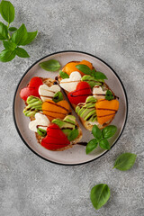 Valentine's Day sandwich with heart-shaped mozzarella, avocado, tomatoes and balsamic sauce. Healthy vegetarian breakfast or snack.