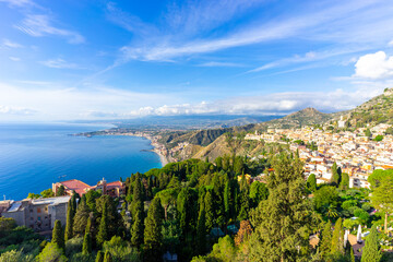 View across the bay between Taormina and Giardini-Naxos with Mount Etna in the background on the island of Sicily &ndash; Italy