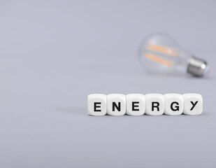 Letter cubes and light bulb with energy concept.