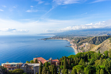 View across the bay between Taormina and Giardini-Naxos with Mount Etna in the background on the island of Sicily &ndash; Italy