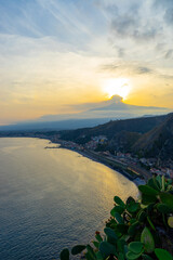 View across the bay between Taormina and Giardini-Naxos with Mount Etna in the background on the island of Sicily &ndash; Italy