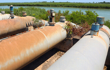 metallic pump pipes to draw water from river for field irrigation