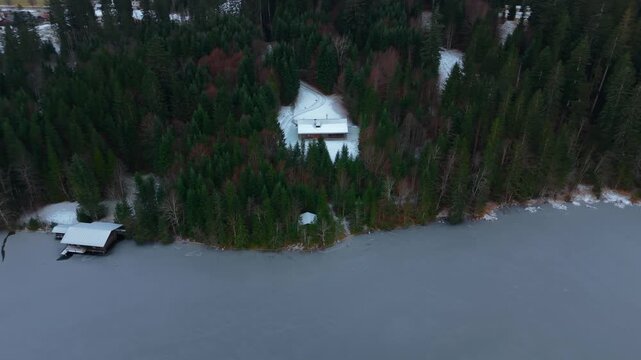 Aerial panorama of Lake Barmsee near Mittenwald, Bavaria. Winter drone video shows icy surface, calm atmosphere and surrounding alpine nature. Luftansicht des Barmsees in Bayern, Deutschland