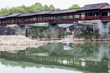 Fototapeta premium Ancient Red Covered Bridge in Wuyuan, China - Traditional Architecture