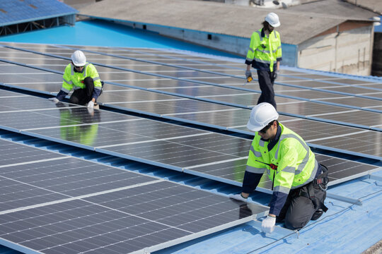 Engineer checking on solar panel on the factory rooftop