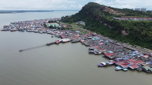 Sandakan, Sabah, Malaysia: Drone view of Kampung Buli Sim Sim, a water village on stilts on the coast of Sandakan reachable by plank walkways, depicts lives of some of the local fishermen village.