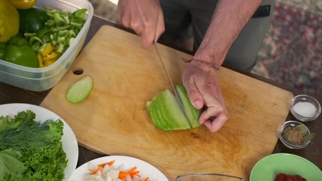 Cutting green daikon into thin strips on a wooden board with halves ne